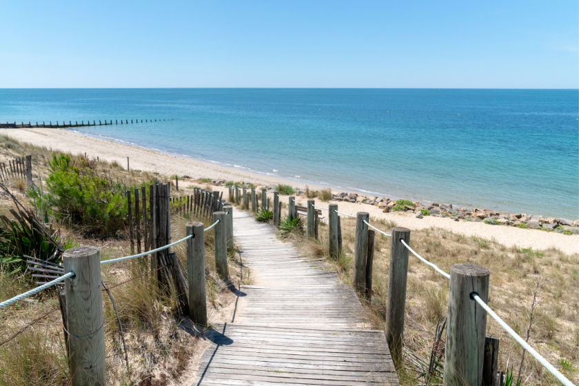 Walkway leading to the sea in the Vendee in France. Best affordable family vacations with HomeExchange. 