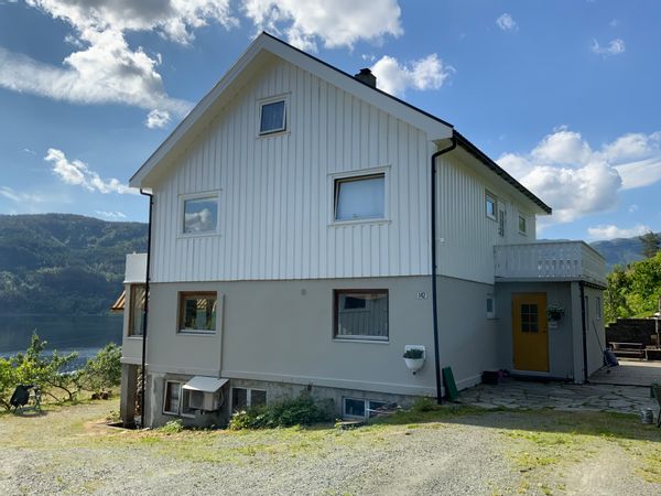 Family home surrounded by mountains and fjords