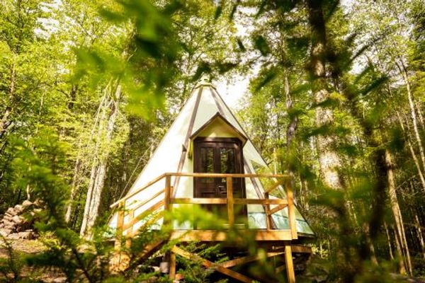 Majestueux Tipi en bois, lac et sentiers en forêt dans un centre de ressourcement