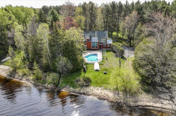 Lake house with a pool.