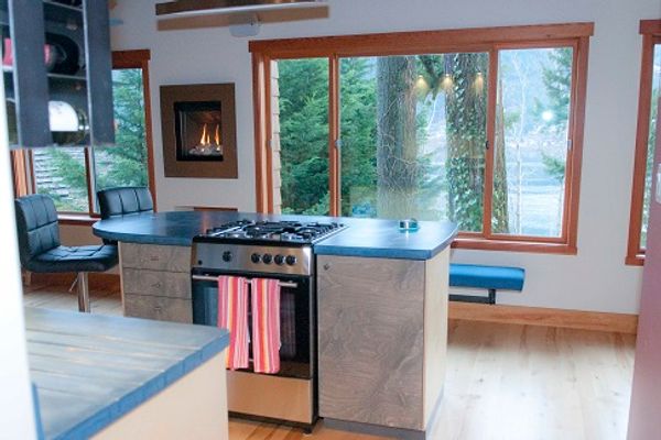 Sunny, lakefront, private home on a beautifully landscaped acre on Kootenay Lake in Nelson BC.