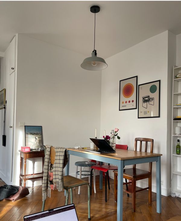 Charming Parisian Mezzanine apartment with balcony views of the city.
